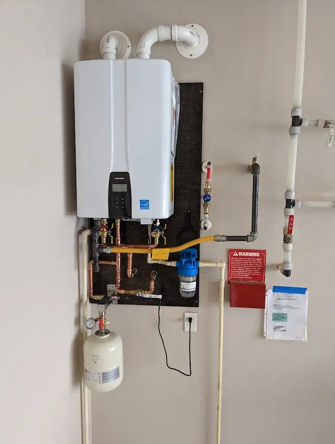 Professional plumber installing copper piping in a Oceanport home